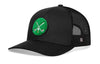 Black trucker snapback hat with green crossed clubs patch and mesh side panels.