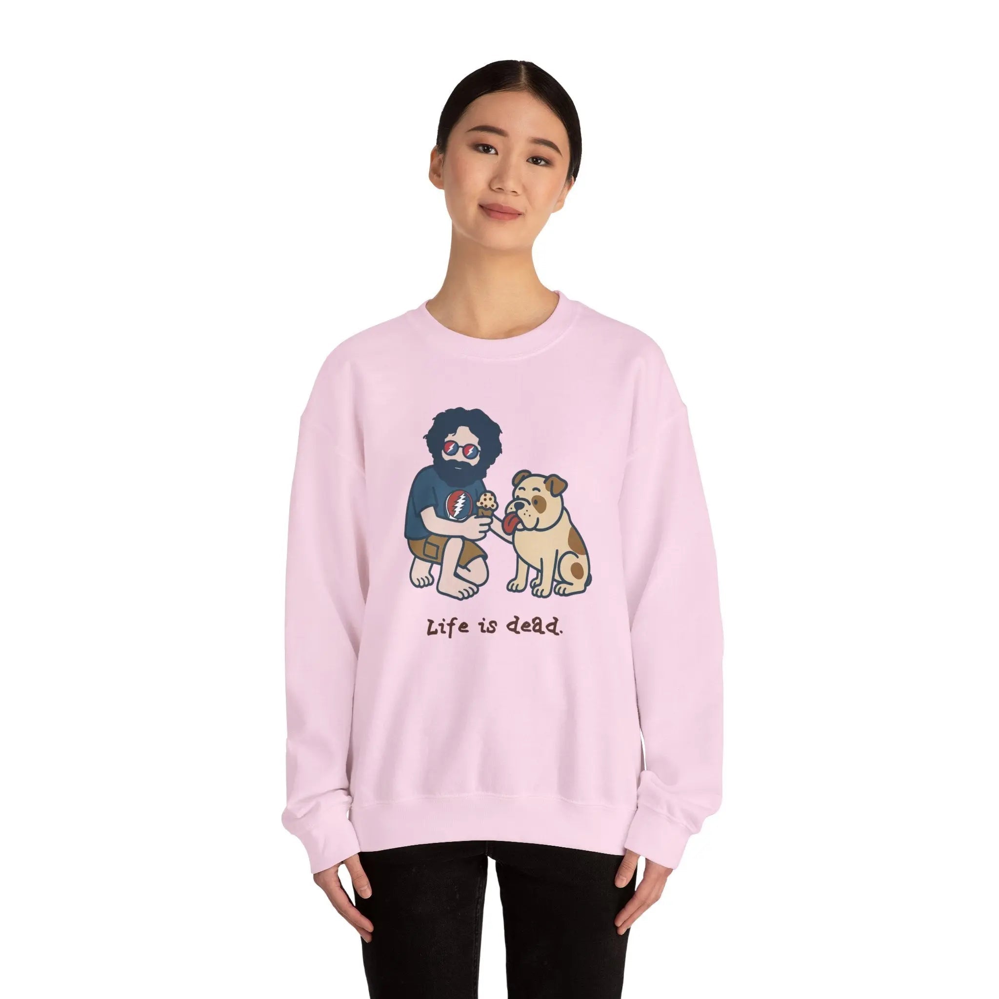 Light pink crewneck sweatshirt with front cartoon graphic; worn by a female model