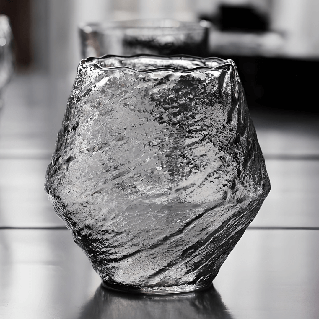 Textured crystal whisky glass, clear with dark reflections, faceted irregular shape
