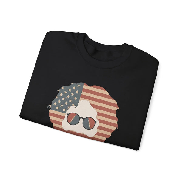 Black crewneck sweatshirt with American flag face graphic and sunglasses, folded