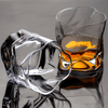 Hoshi crystal whisky tumbler with amber whisky and clear reflections, faceted pattern