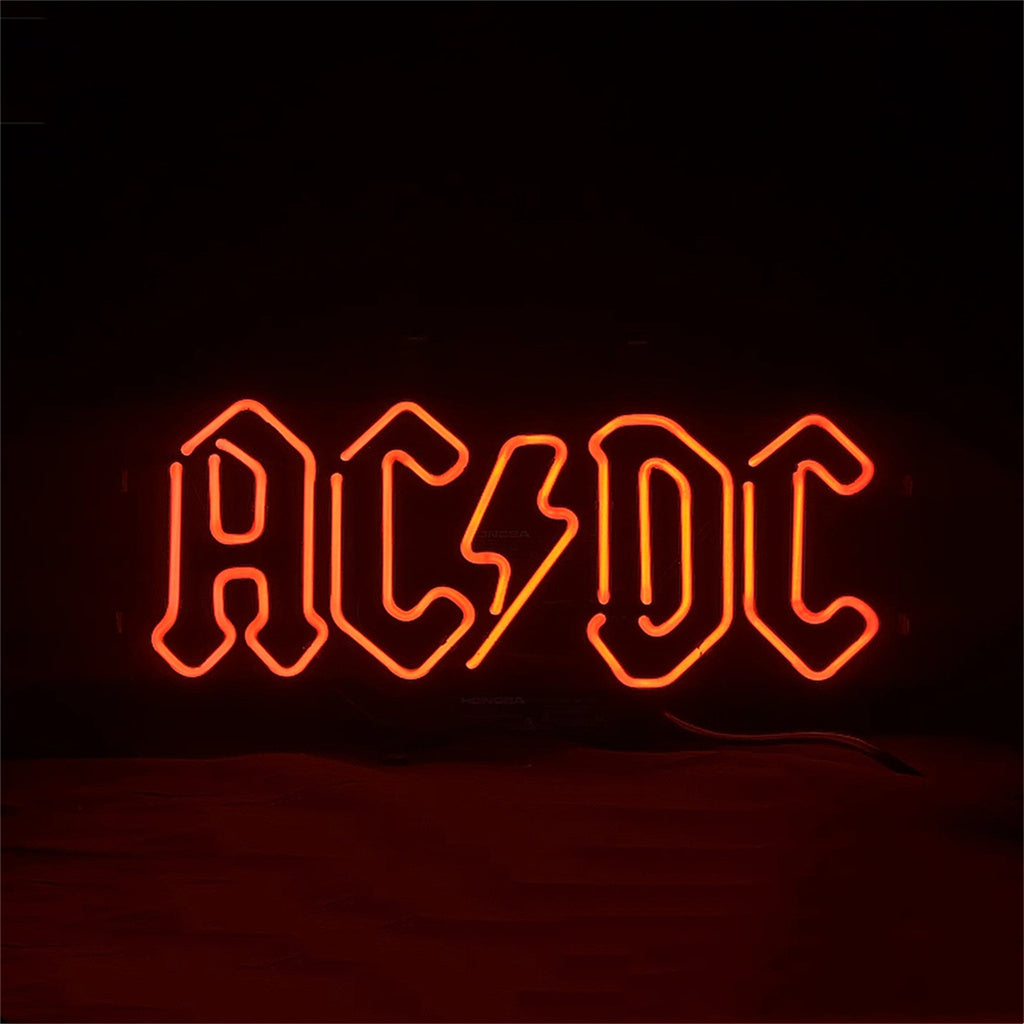 AC/DC neon sign glowing orange 'AC/DC' letters with power wire