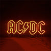 AC/DC neon sign with glowing yellow-orange 'AC/DC' letters