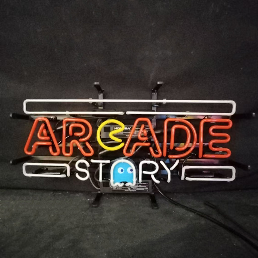 Neon sign “ARCADE STORY” with white tubing frame, orange letters, blue ghost front.