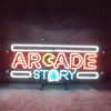 Neon sign “ARCADE STORY” with white rails, orange letters, blue ghost detail.