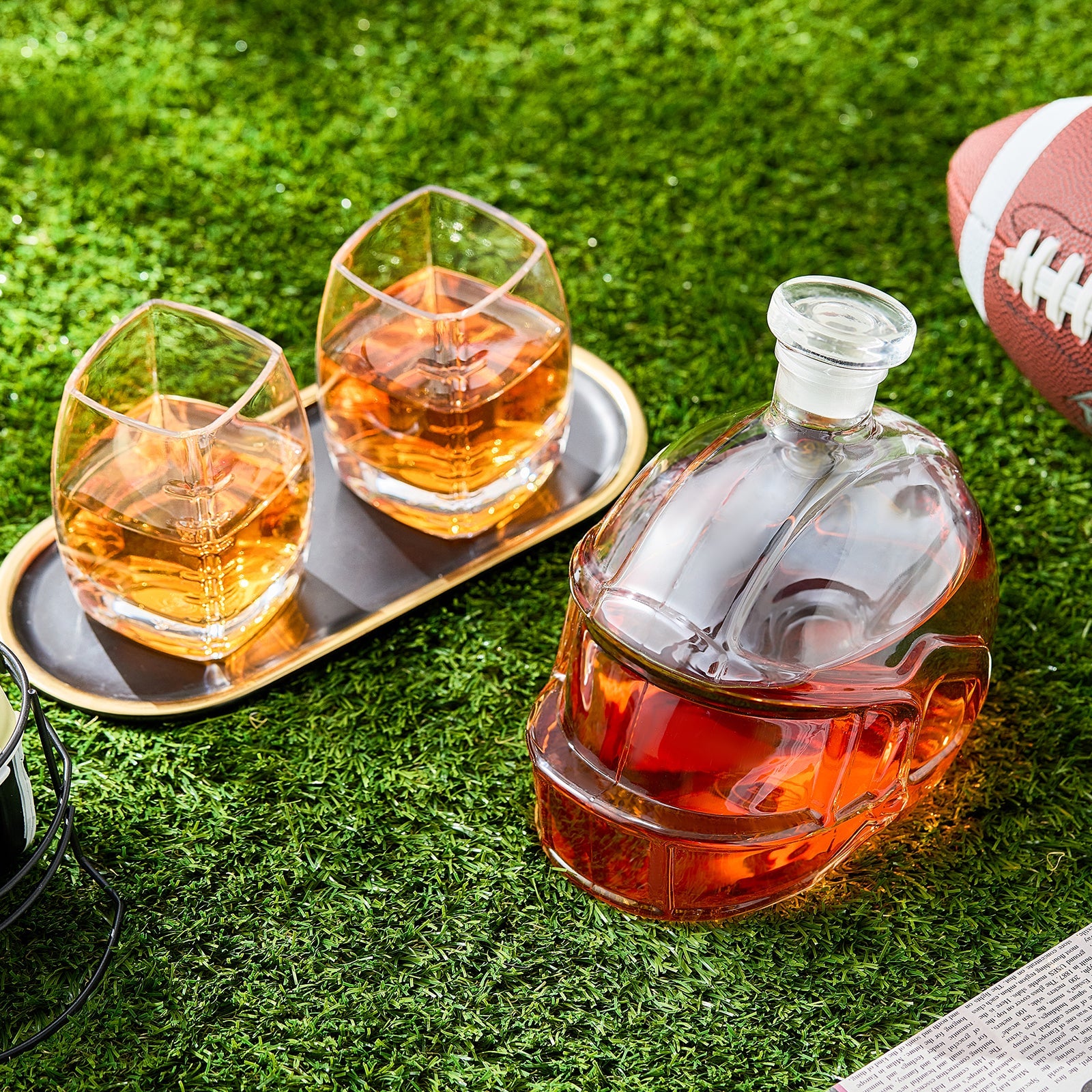 Football-shaped whiskey decanter with amber tumblers and a tray
