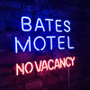 Neon sign reading BATES MOTEL (blue) and NO VACANCY (red), centered.