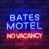 Neon sign reading BATES MOTEL (blue) and NO VACANCY (red).