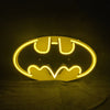 Neon bat logo sign with bright yellow oval glow