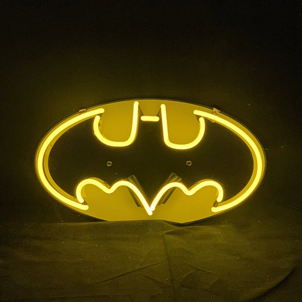 Neon bat logo sign with bright yellow oval glow