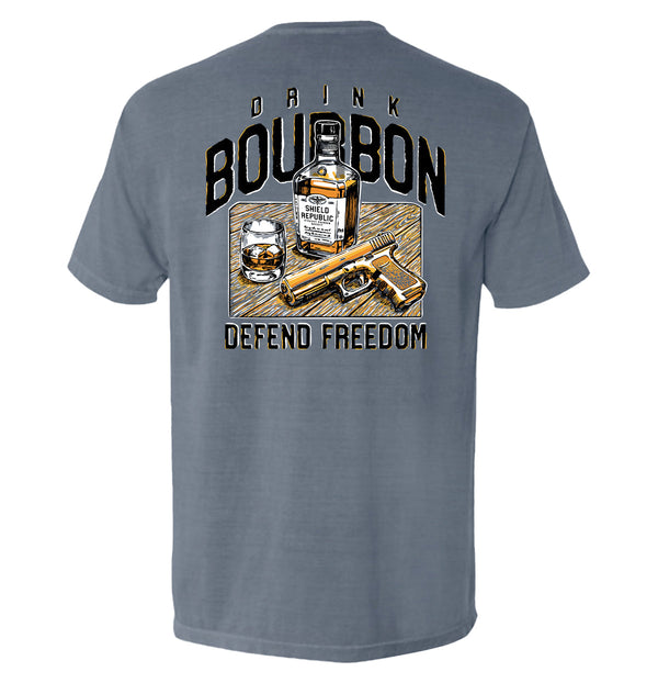 Blue-gray T-shirt with back graphic: bourbon bottle, DRINK/BOURBON text, DEFEND FREEDOM