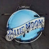 Blue Moon beer neon logo sign on metal frame, glowing blue circle and script