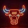 Neon bull head wall sign with glowing orange and blue outline horns