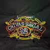 Chivas Regal 12 neon whiskey sign mounted on frame with power cords, red and yellow
