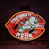 Cincinnati Reds neon sign featuring mascot holding a bat, glowing red and yellow ring