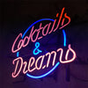Neon cocktail and dreams sign in blue and red glowing script with dark pink accents