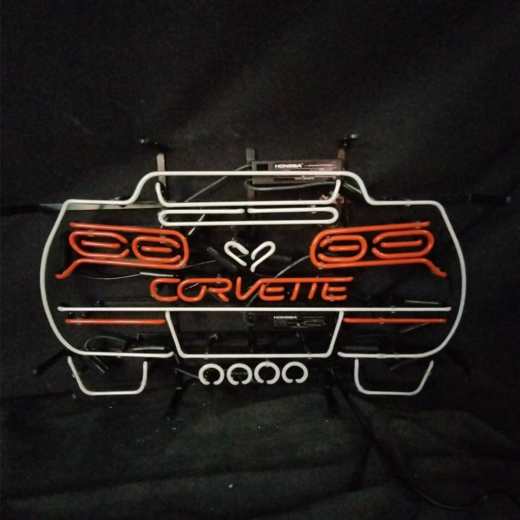 Neon Corvette car sign with white outline and orange 'CORVETTE' text