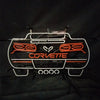 Neon Corvette car sign with white outline and orange 'CORVETTE' text
