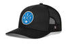 Black trucker hat with blue DET X logo patch, curved brim, and mesh side panels.