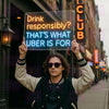 LED neon sign on clear panel: 'Drink responsibly? THAT'S WHAT UBER IS FOR'