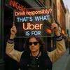 LED neon sign on clear panel: 'Drink responsibly? THAT'S WHAT Uber IS FOR'