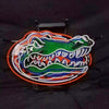 Neon alligator face sign with green head, blue stripes, and orange outer border, metal mount