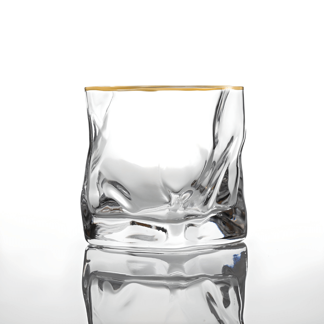 Clear crystal whisky tumbler with gold rim and faceted sides