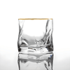 Clear crystal whisky tumbler with gold rim and faceted sides