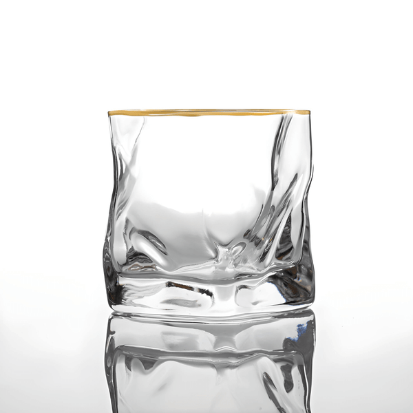 Clear crystal whisky tumbler with gold rim and faceted sides