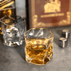 Gold Hoshi whisky glass with gold rim, amber-tinted cut crystal, filled with ice