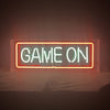 Neon sign reading “GAME ON” in an orange-red framed glow with green text