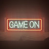 Neon sign reading “GAME ON” with orange-red frame and green text
