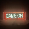 Neon sign reading “GAME ON” with orange-red frame and white text