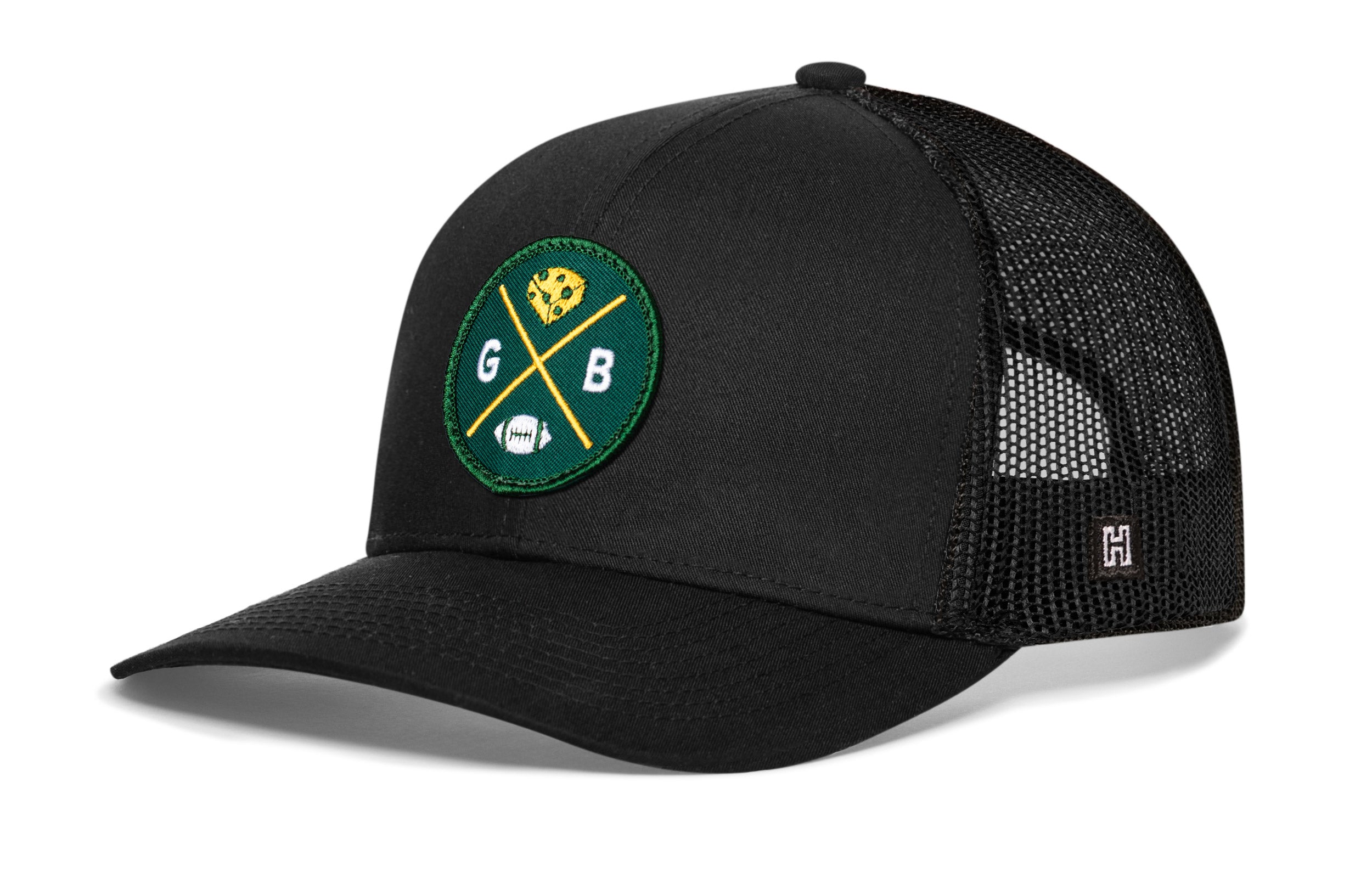 Black trucker hat with green GB logo patch and mesh side panels.