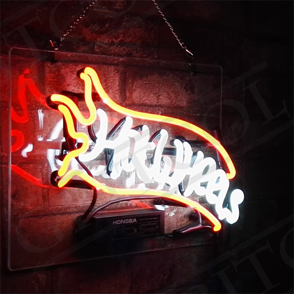 Hot Wheels neon sign close-up with yellow border over white script on black metal backing