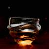 Crystal whisky glass with amber whisky, wide bowl and fluted base