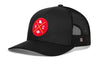 Black trucker cap with red round logo patch and black mesh side panels