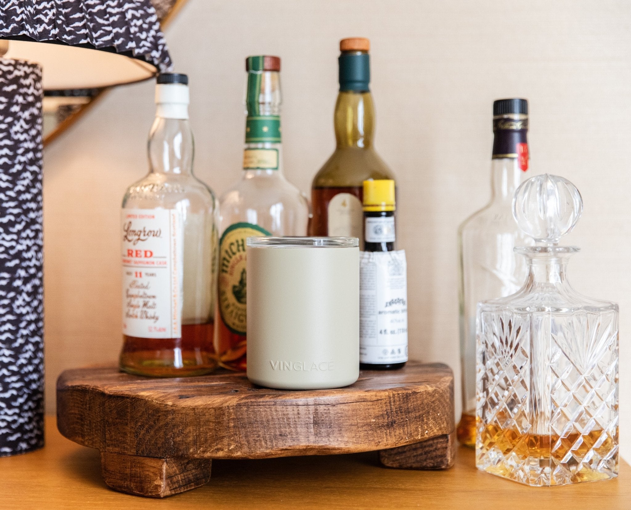 Light khaki insulated whiskey tumbler with deer emblem and removable glass insert