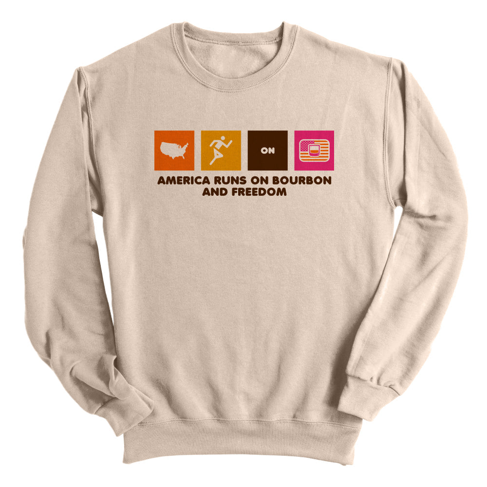Tan sweatshirt with multicolor “America Runs on Bourbon and Freedom” front graphic
