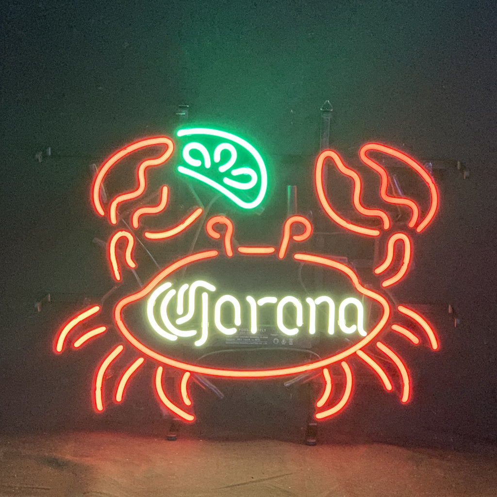 Neon light sign shaped like a crab with Corona text, red and green glow