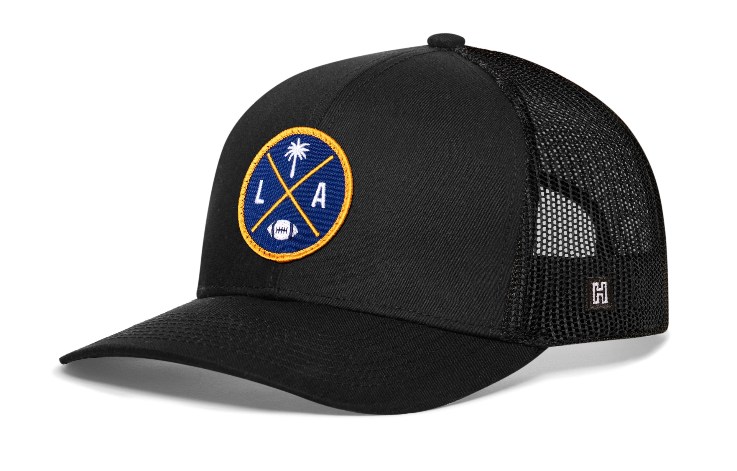 Dark navy trucker cap with mesh side panels and round LA X logo patch