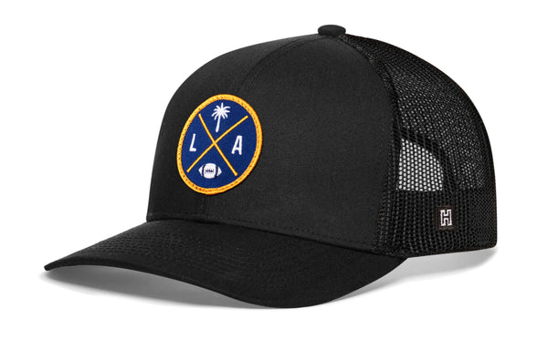 Dark navy trucker cap with mesh side panels and round LA X logo patch