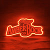 Neon beer sign with Michelob Amber Bock logo in red and yellow glow