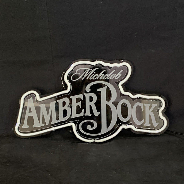 Backlit beer neon sign with Michelob Amber Bock logo, white outline on dark surface
