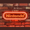 Neon light sign reading Nintendo, bright white-red glow on brick wall with chains
