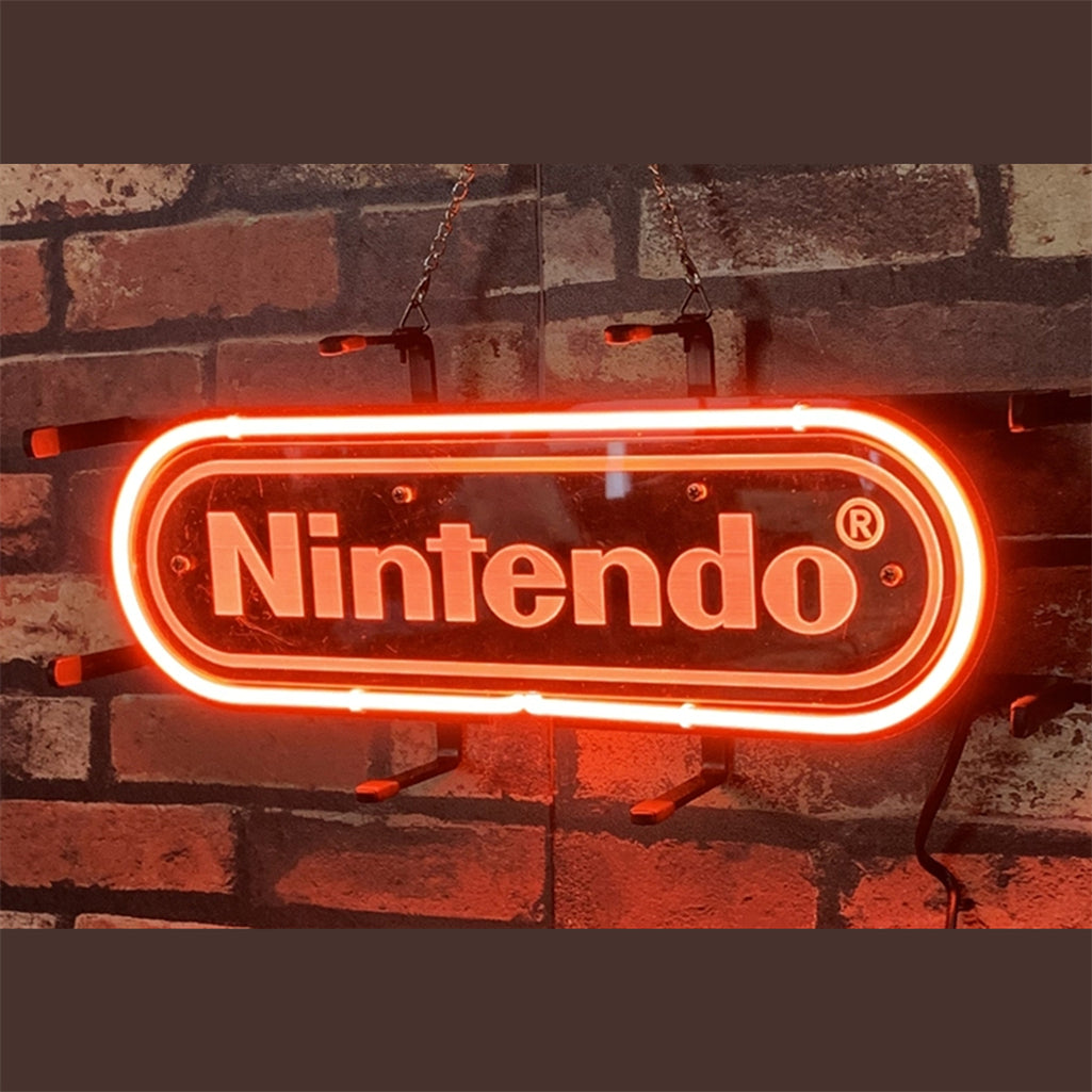 Neon light sign reading Nintendo, glowing on brick wall with visible power cable