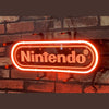 Neon light sign reading Nintendo, glowing on brick wall with visible power cable