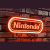 Neon light sign reading Nintendo with glowing white border on brick wall