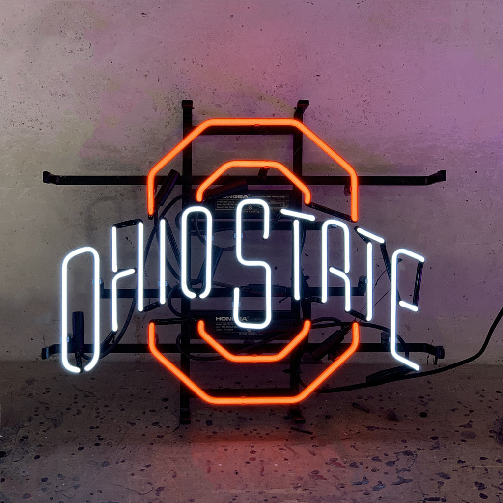 Neon light sign with orange octagon frame and cool white glowing letters