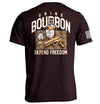 Rust-red T-shirt with back graphic: bourbon bottle, DRINK/BOURBON text, DEFEND FREEDOM
